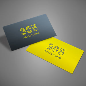 Two rectangular stickers laying on top of a grey surface