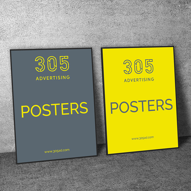 Two frame posters lean against the wall, custom printed posters